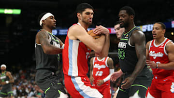 Apr 10, 2025; Memphis, Tennessee, USA; Memphis Grizzlies forward Santi Aldama (7) collects a rebound over Minnesota Timberwolves guard Nickeil Alexander-Walker (9) and forward Julius Randle (30) during the fourth quarter at FedExForum. Mandatory Credit: Petre Thomas-Imagn Images