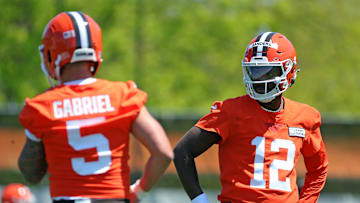 Cleveland Browns quarterback Shedeur Sanders (12) watches quarterback Dillon Gabriel (5) during day two of NFL rookie minicamp at the Cleveland Browns training facility on Saturday, May 10, 2025, in Berea, Ohio.