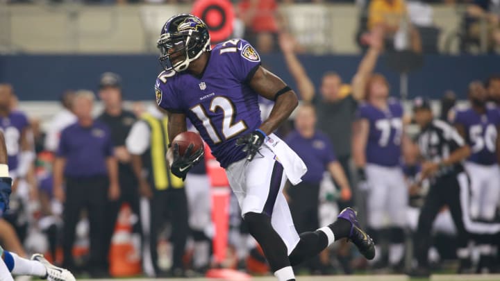 Aug 16, 2014; Arlington, TX, USA; Baltimore Ravens wide receiver Jacoby Jones (12) runs after making a catch against the Dallas Cowboys at AT&T Stadium. Baltimore beat Dallas 37-30. Mandatory Credit: Tim Heitman-USA TODAY Sports