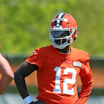 Cleveland Browns quarterback Shedeur Sanders (12) watches quarterback Dillon Gabriel (5) during day two of NFL rookie minicamp at the Cleveland Browns training facility on Saturday, May 10, 2025, in Berea, Ohio.
