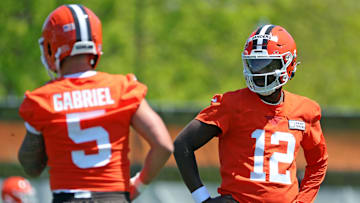 Cleveland Browns quarterback Shedeur Sanders (12) watches quarterback Dillon Gabriel (5) during day two of NFL rookie minicamp at the Cleveland Browns training facility on Saturday, May 10, 2025, in Berea, Ohio.
