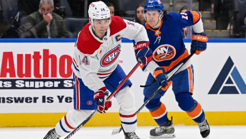 Apr 11, 2024; Elmont, New York, USA; Montreal Canadiens center Nick Suzuki (14) attempts a pass against the New York Islanders during the first period at UBS Arena. Mandatory Credit: Dennis Schneidler-USA TODAY Sports
