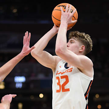 Mar 13, 2025; Indianapolis, IN, USA; Illinois Fighting Illini guard Kasparas Jakucionis (32) shoots over Iowa Hawkeyes forward Payton Sandfort (20) during the first half at Gainbridge Fieldhouse. Mandatory Credit: Robert Goddin-Imagn Images