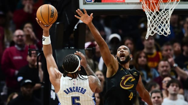 Orlando Magic forward Paolo Banchero (5) shoots over the defense of Cleveland Cavaliers forward Evan Mobley (4).