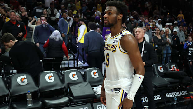 Apr 13, 2025; Portland, Oregon, USA; Los Angeles Lakers guard Bronny James (9) waits for his team to exit Moda Center after t