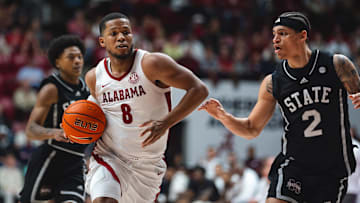 Feb 25, 2025; Tuscaloosa, Alabama, USA; Alabama Crimson Tide guard Chris Youngblood (8) drives against Mississippi State Bulldogs guard Dellquan Warren (6) and guard Riley Kugel (2) during the second half at Coleman Coliseum. Mandatory Credit: Will McLelland-Imagn Images