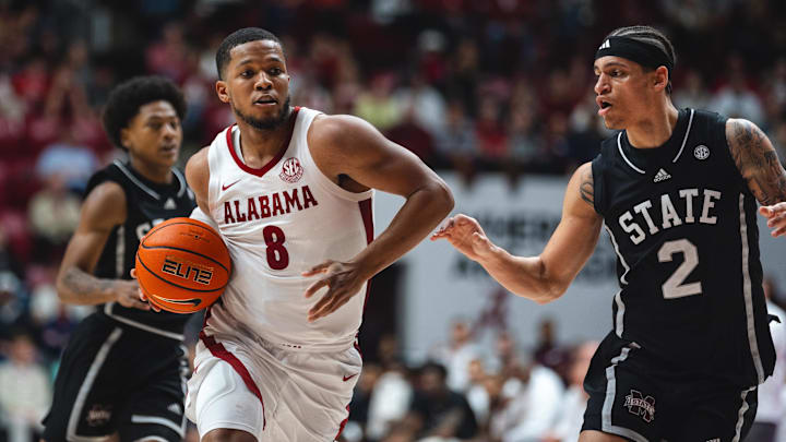 Feb 25, 2025; Tuscaloosa, Alabama, USA; Alabama Crimson Tide guard Chris Youngblood (8) drives against Mississippi State Bulldogs guard Dellquan Warren (6) and guard Riley Kugel (2) during the second half at Coleman Coliseum. Mandatory Credit: Will McLelland-Imagn Images