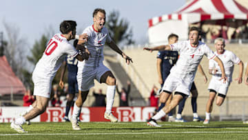 Jansen Miller (5) celebrates with Tommy Mihalic (10) and Josh Maher (4) after his golden goal sent Indiana to a 2-1 victory over Akron at Bill Armstrong Stadium on Sunday, Nov. 24, 2024. Indiana advanced to the NCAA men's soccer Sweet 16.