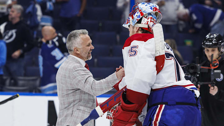 May 3, 2026; Tampa, Florida, USA; the Montreal Canadiens head coach Martin St. Louis and goalie Jakub Dobes (75) react to beating the Tampa Bay Lightning in game seven of the first round of the 2026 Stanley Cup Playoffs at Benchmark International Arena. Mandatory Credit: Morgan Tencza-Imagn Images
