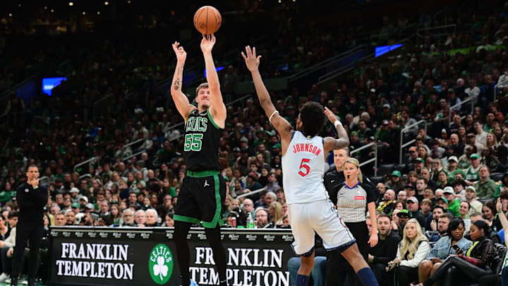 Apr 6, 2025; Boston, Massachusetts, USA; Boston Celtics forward Baylor Scheierman (55) shoots the ball over Washington Wizards guard AJ Johnson (5) during the second half at TD Garden. Mandatory Credit: Bob DeChiara-Imagn Images