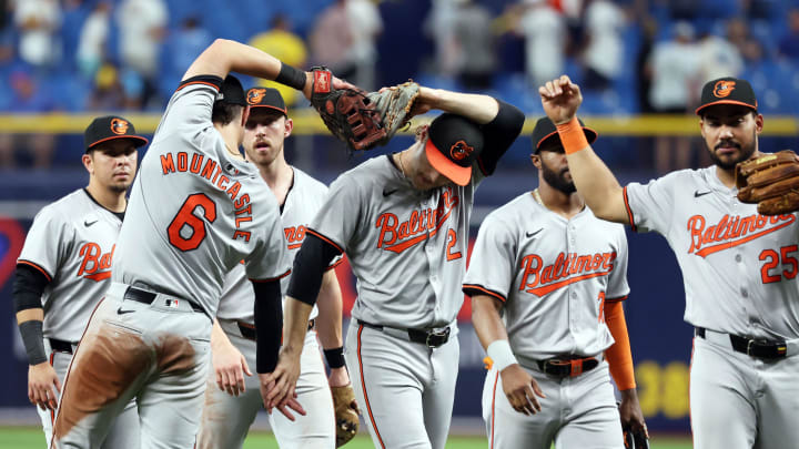 Jun 10, 2024; St. Petersburg, Florida, USA;Baltimore Orioles shortstop Gunnar Henderson (2), first base Ryan Mountcastle (6) and teammates celebrates after they beat the Tampa Bay Rays at Tropicana Field. Mandatory Credit: Kim Klement Neitzel-USA TODAY Sports