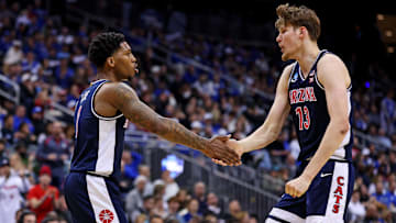Arizona Wildcats guard Caleb Love (1) and forward Henri Veesaar (13) react during the first half against the Duke Blue Devils during an East Regional semifinal of the 2025 NCAA tournament at Prudential Center.