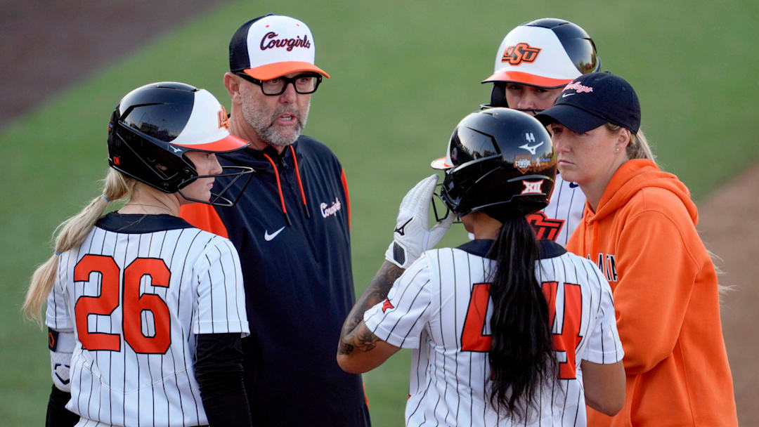 Oklahoma State coach Kenny Gajewski and assistant Vanessa Shippy-Fletcher talk with Oklahoma State infielder Rosie Davis (26) and infielder Tallen Edwards (44) during an NCAA softball game between the Oklahoma State University Cowgirls (OSU) and the Utah Utes in Stillwater, Okla., Friday, May 2, 2025.