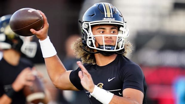  Carrollton Trojans quarterback Julian Lewis (10) runs through drills during warmups before their game