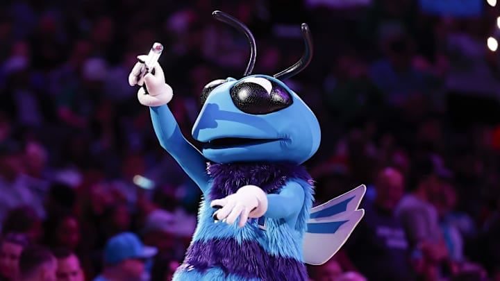 Nov 2, 2024; Charlotte, North Carolina, USA; Charlotte Hornets mascot Buzz entertains fans during a timeout of a game against the Boston Celtics at Spectrum Center. Mandatory Credit: Nell Redmond-Imagn Images Nov 2, 2024; Charlotte, North Carolina, USA; Charlotte Hornets mascot Buzz entertains fans during a timeout of a game against the Boston Celtics at Spectrum Center. Mandatory Credit: Nell Redmond-Imagn Images