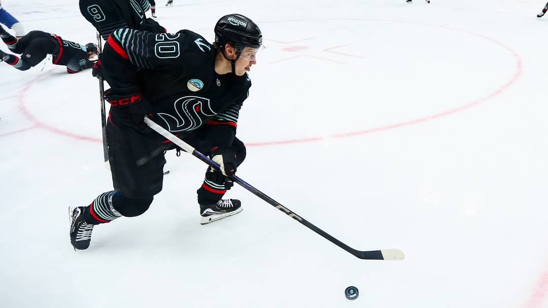 Mar 4, 2026; Seattle, Washington, USA; Seattle Kraken right wing Eeli Tolvanen (20) moves the puck during the second period against the St. Louis Blues at Climate Pledge Arena. Mandatory Credit: Kevin Ng-Imagn Images