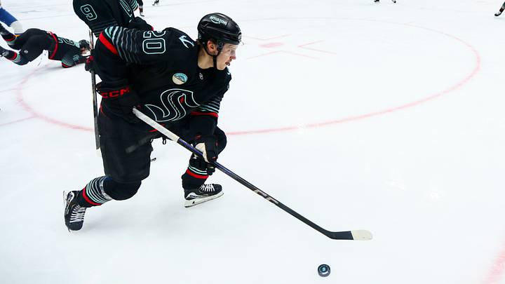 Mar 4, 2026; Seattle, Washington, USA; Seattle Kraken right wing Eeli Tolvanen (20) moves the puck during the second period against the St. Louis Blues at Climate Pledge Arena. Mandatory Credit: Kevin Ng-Imagn Images