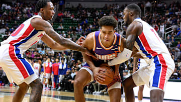 Oct 8, 2024; East Lansing, Michigan, USA;  Phoenix Suns center Oso Ighodaro (4) gets trapped by Detroit Pistons forward Ron Holland II (00) and teammate forward Paul Reed (7): Dale Young-Imagn Images