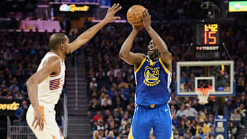 Dec 28, 2024; San Francisco, California, USA; Golden State Warriors forward Draymond Green (23) shoots a three point basket against Phoenix Suns forward Kevin Durant (35) during the second quarter at Chase Center. Mandatory Credit: Robert Edwards-Imagn Images