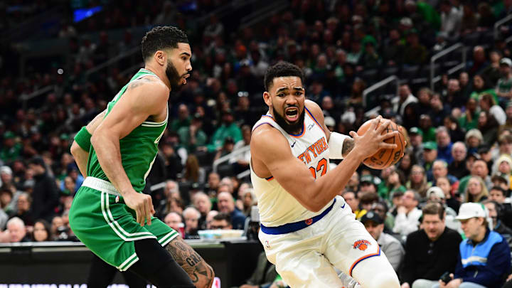 Feb 23, 2025; Boston, Massachusetts, USA;  New York Knicks center Karl-Anthony Towns (32) controls the ball while Boston Celtics forward Jayson Tatum (0) defends during the first half at TD Garden. Mandatory Credit: Bob DeChiara-Imagn Images