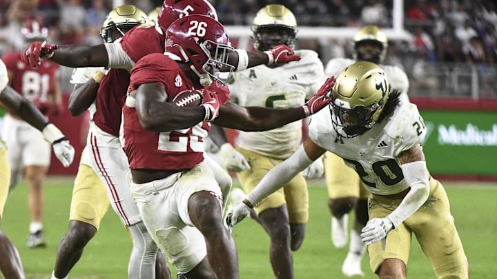 Sep 7, 2024; Tuscaloosa, Alabama, USA;  Alabama Crimson Tide running back Jam Miller (26) stiff arms Alabama Crimson Tide defensive lineman Jah-Marien Latham (20) on a 54-yard touchdown run at Bryant-Denny Stadium. Alabama won 42-16. Mandatory Credit: Gary Cosby Jr.-Imagn Images