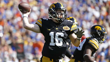 Jan 2, 2017; Tampa , FL, USA; Iowa Hawkeyes quarterback C.J. Beathard (16) throws the ball against the Florida Gators during the first quarter at Raymond James Stadium. Mandatory Credit: Kim Klement-Imagn Images