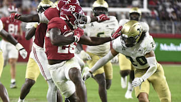 Sep 7, 2024; Tuscaloosa, Alabama, USA;  Alabama Crimson Tide running back Jam Miller (26) stiff arms Alabama Crimson Tide defensive lineman Jah-Marien Latham (20) on a 54-yard touchdown run at Bryant-Denny Stadium. Alabama won 42-16. Mandatory Credit: Gary Cosby Jr.-Imagn Images