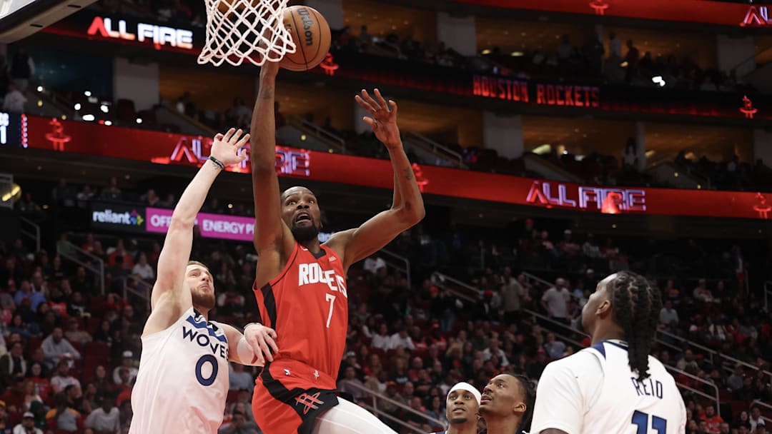 Jan 16, 2026; Houston, Texas, USA; Houston Rockets forward Kevin Durant (7) dunks against Minnesota Timberwolves guard Donte DiVincenzo (0) in the second half at Toyota Center. Mandatory Credit: Thomas Shea-Imagn Images