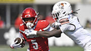 Sep 20, 2025; Louisville, Kentucky, USA;  Louisville Cardinals wide receiver Caullin Lacy (5) is defended by Bowling Green Falcons cornerback MJ Cannon (2) during the second half at L&N Federal Credit Union Stadium. Louisville defeated Bowling Green 40-17. Mandatory Credit: Jamie Rhodes-Imagn Images