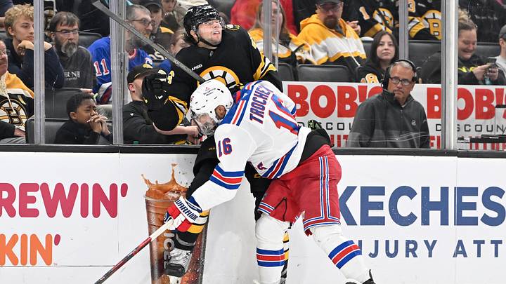 Oct 4, 2025; Boston, Massachusetts, USA; New York Rangers center Vincent Trocheck (16) checks Boston Bruins defenseman Andrew Peeke (26) into the boards during the third period period at TD Garden. Mandatory Credit: Eric Canha-Imagn Images