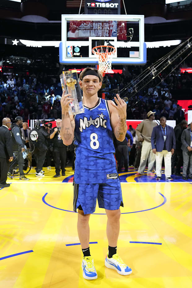 Osceola Magic guard Mac McClung celebrates with the trophy after winning the NBA slam dunk competition. 