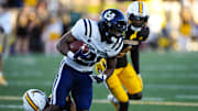 Oct 26, 2024; Laramie, Wyoming, USA; Utah State Aggies running back Rahsul Faison (3) runs against the Wyoming Cowboys during the first quarter at Jonah Field at War Memorial Stadium. Mandatory Credit: Troy Babbitt-Imagn Images