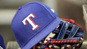 A hat and glove of a Texas Rangers player during a game against the Toronto Blue Jays at Rogers Centre in 2024.
