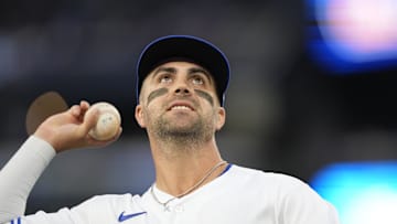Sep 8, 2023; Toronto, Ontario, CAN; Toronto Blue Jays second baseman Whit Merrifield (15) goes to throw a ball to a fan during the second inning against the Kansas City Royals at Rogers Centre. Mandatory Credit: John E. Sokolowski-Imagn Images