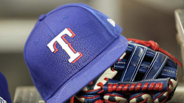 Jul 26, 2024; Toronto, Ontario, CAN; A hat and glove of a Texas Rangers player during a game against the Toronto Blue Jays at Rogers Centre. Mandatory Credit: John E. Sokolowski-Imagn Images