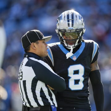 Jan 7, 2024; Charlotte, North Carolina, USA; Carolina Panthers cornerback Jaycee Horn (8) talks with umpire Tra Blake (33) during the first quarter against the Tampa Bay Buccaneers at Bank of America Stadium.