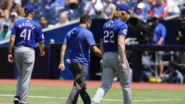 Rangers starter Jon Gray left the game before throwing a pitch with a right groin strain Sunday in Toronto.