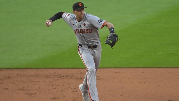 Jul 5, 2024; Cleveland, Ohio, USA; San Francisco Giants shortstop Nick Ahmed (16) turns a double play in the first inning against the Cleveland Guardians at Progressive Field. 