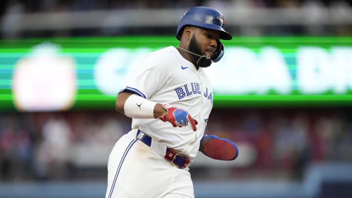 Jul 26, 2024; Toronto, Ontario, CAN; Toronto Blue Jays first baseman Vladimir Guerrero Jr. (27) runs to home to score on a double hit by second baseman Spencer Horwitz (not pictured) during first inning against the Texas Rangers at Rogers Centre. Mandatory Credit: John E. Sokolowski-USA TODAY Sports