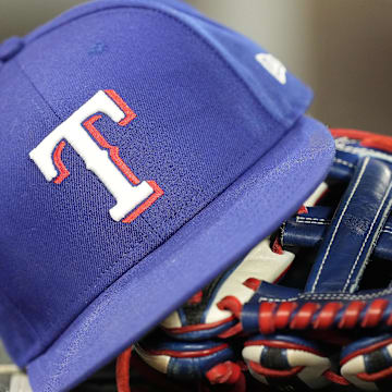 A hat and glove of a Texas Rangers player during a game against the Toronto Blue Jays at Rogers Centre.