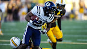 Oct 26, 2024; Laramie, Wyoming, USA; Utah State Aggies running back Rahsul Faison (3) runs against the Wyoming Cowboys during the first quarter at Jonah Field at War Memorial Stadium. Mandatory Credit: Troy Babbitt-Imagn Images