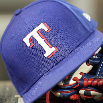 Jul 26, 2024; Toronto, Ontario, CAN; A hat and glove of a Texas Rangers player during a game against the Toronto Blue Jays at Rogers Centre.