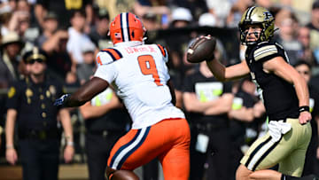 Oct 4, 2025; West Lafayette, Indiana, USA; Purdue Boilermakers quarterback Ryan Browne (15) runs with the ball against Illinois Fighting Illini defensive end Leon Lowery (9) during the first quarter at Ross-Ade Stadium. Mandatory Credit: Marc Lebryk-Imagn Images