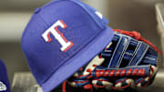 A hat and glove of a Texas Rangers player during a game against the Toronto Blue Jays at Rogers Centre.