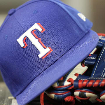 A hat and glove of a Texas Rangers player during a game against the Toronto Blue Jays at Rogers Centre. 