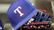 A hat and glove of a Texas Rangers player during a game against the Toronto Blue Jays at Rogers Centre.