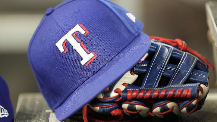 Jul 26, 2024; Toronto, Ontario, CAN; A hat and glove of a Texas Rangers player during a game against the Toronto Blue Jays at Rogers Centre. Mandatory Credit: John E. Sokolowski-Imagn Images