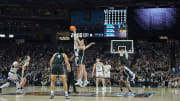 Connecticut Huskies center Donovan Clingan (32) and Purdue Boilermakers center Zach Edey (15) reach for the opening tipoff during the first half of the national championship game of the Final Four of the 2024 NCAA Tournament at State Farm Stadium.