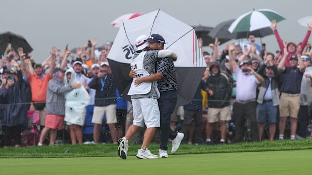 J.J. Spaun celebrates with his caddie after winning the 2025 U.S. Open.
