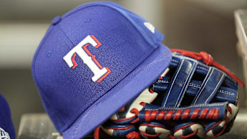 Jul 26, 2024; Toronto, Ontario, CAN; A hat and glove of a Texas Rangers player during a game against the Toronto Blue Jays at Rogers Centre. Mandatory Credit: John E. Sokolowski-Imagn Images